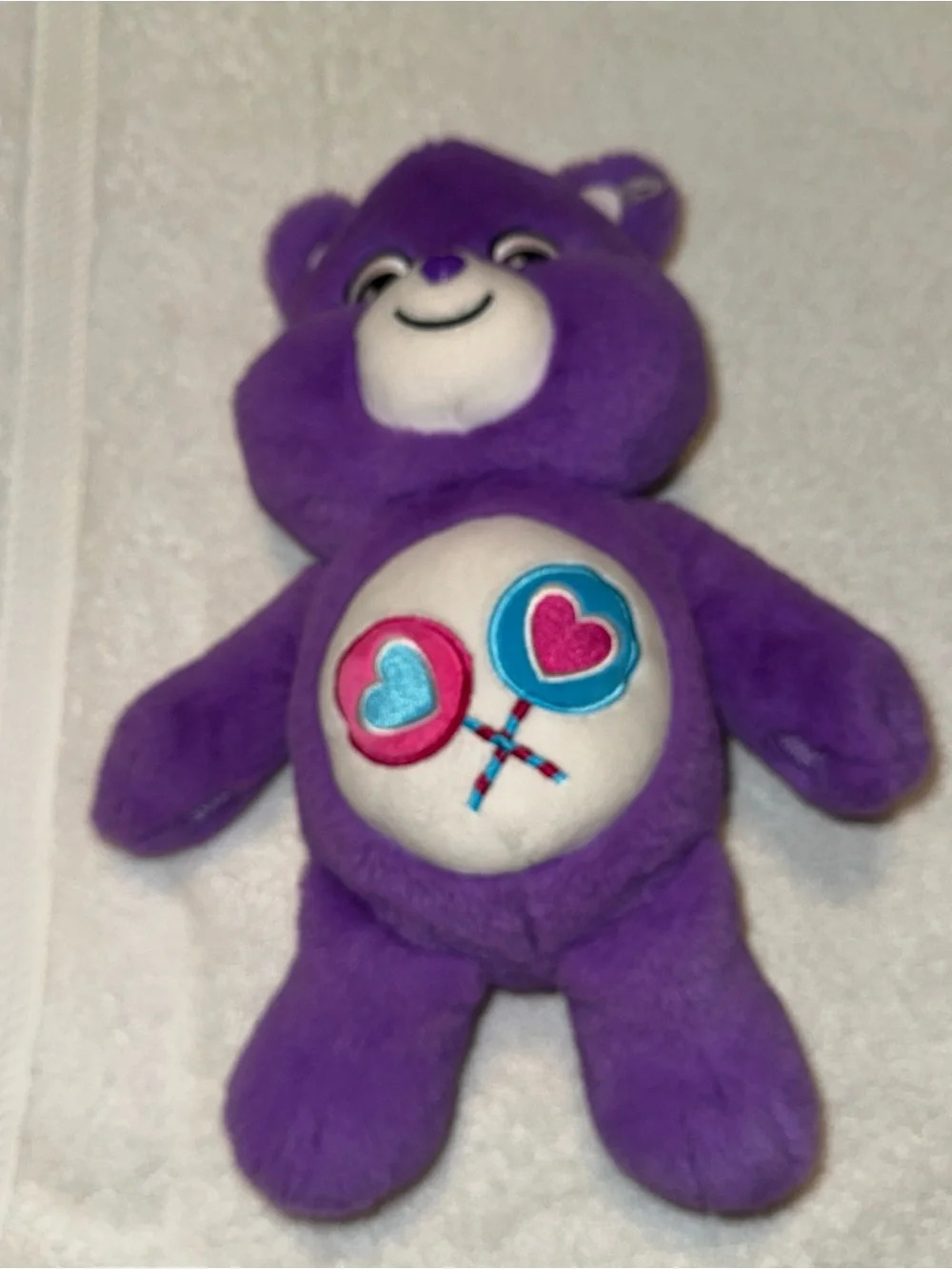 Care Bears Purple Plush with Pink & Blue Heart Lollipop Belly Badge
